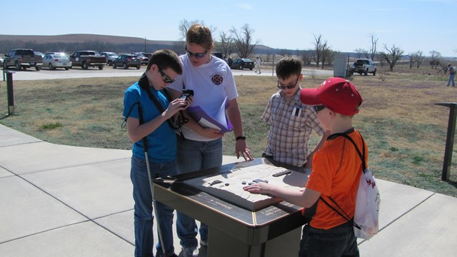 visitors preparing the Trekker Breeze units before hiking the trails